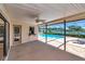 Covered patio with pool, lake view, and ceiling fan at 6056 Fall River Dr, New Port Richey, FL 34655