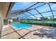 Screened-in pool area with brick pavers and lake view at 6056 Fall River Dr, New Port Richey, FL 34655