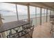 Enclosed balcony featuring a table, chairs, and stunning water views at 6060 Shore S Blvd # 200, Gulfport, FL 33707