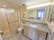 The bathroom has a glass shower and decorative mirror over the sink at 6060 Shore S Blvd # 200, Gulfport, FL 33707