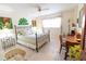 Comfortable bedroom with tile flooring, a ceiling fan, and a sunny window at 6060 Shore S Blvd # 200, Gulfport, FL 33707