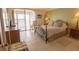 Bedroom featuring a queen bed, tile floors, and access to the balcony at 6060 Shore S Blvd # 200, Gulfport, FL 33707