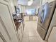 Open kitchen design with stainless steel appliances, granite counters, and tile flooring at 6060 Shore S Blvd # 200, Gulfport, FL 33707