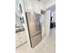 Kitchen featuring stainless steel refrigerator, tile floors, and convenient access to the laundry area at 6060 Shore S Blvd # 200, Gulfport, FL 33707