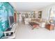 Open living area with tile flooring and a tropical wall mural at 6060 Shore S Blvd # 200, Gulfport, FL 33707