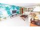 Inviting living room featuring a tropical wall mural, tile floor, and modern TV at 6060 Shore S Blvd # 200, Gulfport, FL 33707