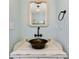 Powder room with copper sink, rope-trimmed mirror, and white washed vanity at 636 16Th Ne Ave, St Petersburg, FL 33704