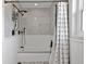 Traditional bathroom with a bathtub and shower combo with decorative black-and-white curtain at 636 16Th Ne Ave, St Petersburg, FL 33704