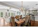 Open-concept dining area connects to the living space, featuring hardwood floors and a chandelier at 636 16Th Ne Ave, St Petersburg, FL 33704