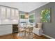 Dining room with bench seating, wine fridge, modern chandelier, and large windows at 636 16Th Ne Ave, St Petersburg, FL 33704