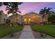 Charming home featuring a well-manicured lawn, mature palm trees, and an inviting front porch at 636 16Th Ne Ave, St Petersburg, FL 33704