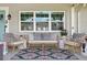 Inviting front porch featuring stylish seating, a patterned rug, and a cozy ambiance for relaxation at 636 16Th Ne Ave, St Petersburg, FL 33704