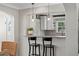 Kitchen cutout to living room. Stainless steel stove top and neutral countertops at 636 16Th Ne Ave, St Petersburg, FL 33704
