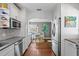 Eat in kitchen with stainless appliances, white cabinets, gray backsplash, and eat in area with breakfast nook at 636 16Th Ne Ave, St Petersburg, FL 33704