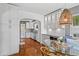 Bright eat-in kitchen features stainless appliances, white cabinets, wine cooler and stylish woven pendant light at 636 16Th Ne Ave, St Petersburg, FL 33704