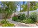 Lush landscaping along the fence with flowering plants and brick pavers at 636 16Th Ne Ave, St Petersburg, FL 33704