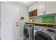 Functional laundry room with washer, dryer, and plenty of cabinet space for storage at 636 16Th Ne Ave, St Petersburg, FL 33704