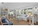 Bright living room with jute rug, white sofa, view to dining and sitting area and plenty of natural light at 636 16Th Ne Ave, St Petersburg, FL 33704