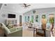Bright and airy living room featuring vaulted ceilings, neutral decor, and French doors to outdoor area at 636 16Th Ne Ave, St Petersburg, FL 33704