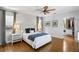 Bright main bedroom featuring hardwood floors, ceiling fan, walk-in closet and ensuite bath at 636 16Th Ne Ave, St Petersburg, FL 33704