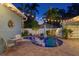 Nighttime view of the pool and patio area with beautiful landscaping and relaxing outdoor seating at 636 16Th Ne Ave, St Petersburg, FL 33704