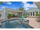 Backyard pool and patio with covered dining area and outdoor kitchen at 636 16Th Ne Ave, St Petersburg, FL 33704