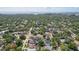 A bird's eye view of a neighborhood with mature trees and a variety of houses along the water at 714 S Lois Ave, Tampa, FL 33609