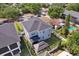 An aerial perspective showing a home's backyard, adjacent properties, and the surrounding neighborhood at 714 S Lois Ave, Tampa, FL 33609