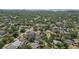 A neighborhood with mature trees and a variety of houses, captured from an aerial perspective at 714 S Lois Ave, Tampa, FL 33609
