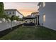 A peaceful backyard setting with a shaded gazebo, patio furniture, and lush landscaping at 714 S Lois Ave, Tampa, FL 33609