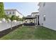 This spacious backyard features a manicured lawn, a gazebo, and lush palm trees at 714 S Lois Ave, Tampa, FL 33609