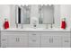 Bright bathroom featuring a double sink vanity with modern fixtures and ample cabinet space at 714 S Lois Ave, Tampa, FL 33609