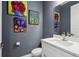 Stylish powder room with unique wall art, modern fixtures, and a sleek white vanity at 714 S Lois Ave, Tampa, FL 33609