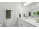 Modern bathroom featuring white vanity with sleek fixtures, toilet, and mirror at 714 S Lois Ave, Tampa, FL 33609
