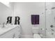 Modern bathroom featuring white cabinets, a glass-enclosed shower, and sleek fixtures at 714 S Lois Ave, Tampa, FL 33609