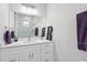 Well-lit bathroom with white cabinets, modern fixtures, and a spacious glass-enclosed shower at 714 S Lois Ave, Tampa, FL 33609