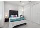 Comfortable bedroom featuring large windows, soft carpet, and a lovely accent chair at 714 S Lois Ave, Tampa, FL 33609