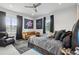 This modern bedroom features astronaut wall hangings, a comfy leather couch and a ceiling fan at 714 S Lois Ave, Tampa, FL 33609