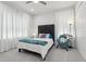 Cozy bedroom featuring plush carpets, a beautifully designed headboard, and soft natural light at 714 S Lois Ave, Tampa, FL 33609