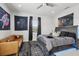 A stylish bedroom decorated with an astronaut tapestry, leather couch, and comfy striped bed at 714 S Lois Ave, Tampa, FL 33609