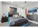 The bedroom has a space-themed tapestry, a striped bed, and matching wood dressers at 714 S Lois Ave, Tampa, FL 33609