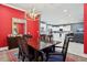 Bright dining area connecting to the kitchen, featuring red walls and a stylish modern table set at 714 S Lois Ave, Tampa, FL 33609