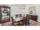 Dining room features a dark wood table, ornate area rug, display cabinet, bright natural light, and buffet at 714 S Lois Ave, Tampa, FL 33609