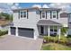 Beautiful two-story home with a three-car garage, manicured landscaping, and a welcoming front porch area at 714 S Lois Ave, Tampa, FL 33609