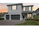 A charming two-story home featuring a spacious three-car garage and well-manicured lawn at 714 S Lois Ave, Tampa, FL 33609