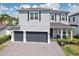 Charming two-story home featuring a three-car garage, well-maintained landscaping, and inviting curb appeal at 714 S Lois Ave, Tampa, FL 33609