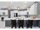 Spacious kitchen with a large island, modern pendant lighting, stainless steel appliances, and sleek white cabinetry at 714 S Lois Ave, Tampa, FL 33609