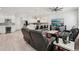 Spacious open layout showcases living room with modern lighting, kitchen, and barstool seating at the island at 714 S Lois Ave, Tampa, FL 33609