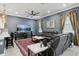 Cozy living room with a ceiling fan, plush seating, a large television and an eye-catching red rug at 714 S Lois Ave, Tampa, FL 33609