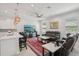 Open-concept living room features a comfortable leather sectional, large TV, and bar seating connected to the kitchen at 714 S Lois Ave, Tampa, FL 33609